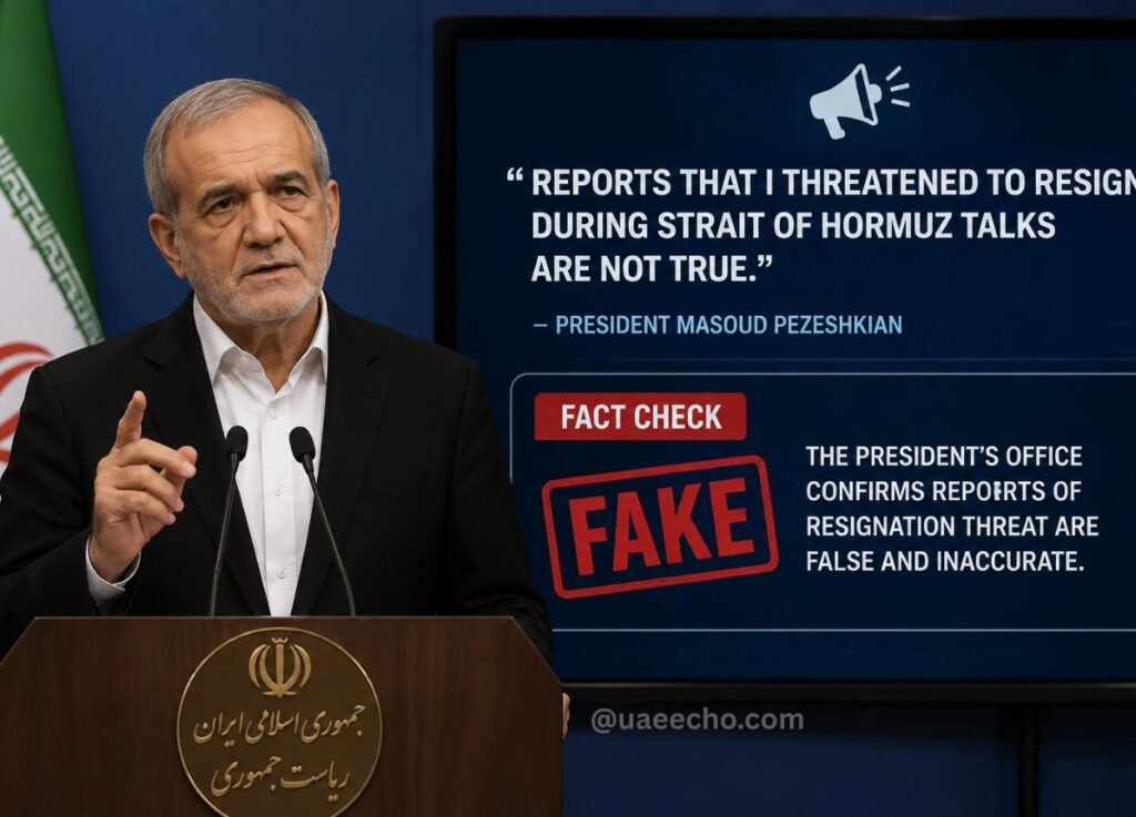 - UAE Echo Older man in a dark suit speaks at a wooden podium with two microphones, a blue screen behind shows 'FACT CHECK' and a red 'FAKE' stamp.