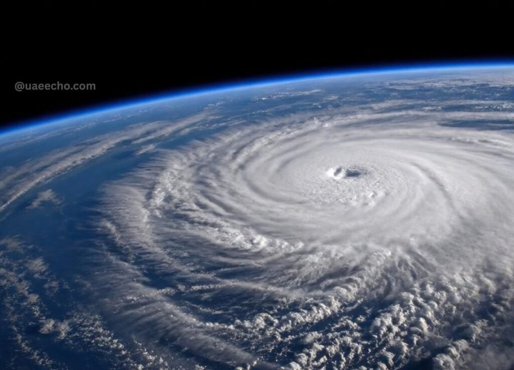 Satellite image of a hurricane with a clear eye and spiraling bands over the ocean, viewed from space.